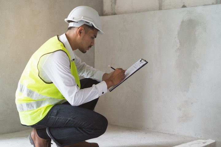 Builder inspection consultancy. Inspector checking material and structure in construction.